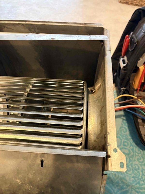Responded to callback regarding recurring loud noise from blower wheel. Inspected furnace unit, focusing on the metal blower assembly and ventilation components. Identified wear on the blower housing and metal surfaces that was causing the noise issue. Serviced the blower wheel to eliminate the noise complaint.