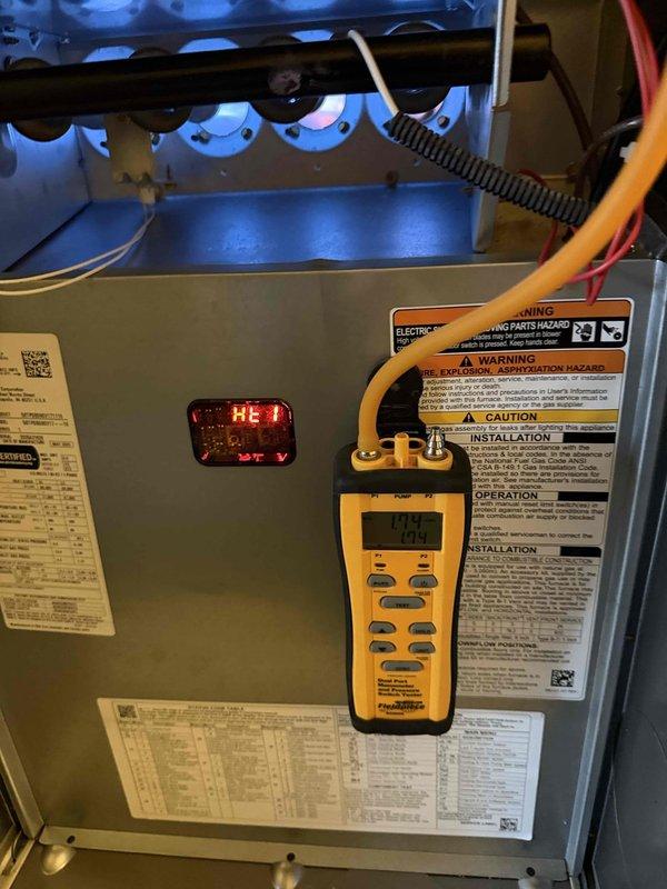 Performed heating maintenance on system and conducted diagnostic testing using digital manometer, which showed pressure reading of 0.04. Electrical testing with clamp meter indicated 15.8 amps during operation. System functioning properly with no issues identified.