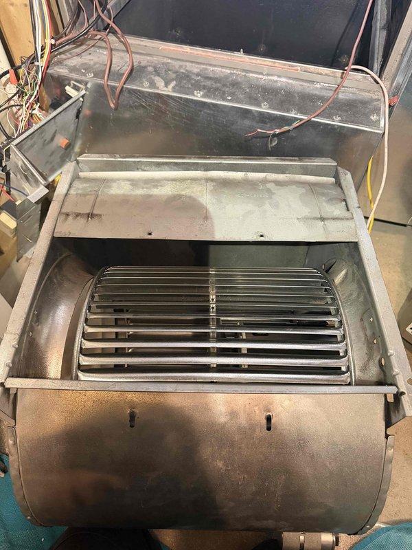 Responded to warranty service call regarding customer-reported blower rattling noise. Inspected HVAC unit, focusing on the blower assembly with fan blades and mounting components. Identified and secured loose hexagonal bolt in the metal mounting collar, eliminating the rattling sound during operation.