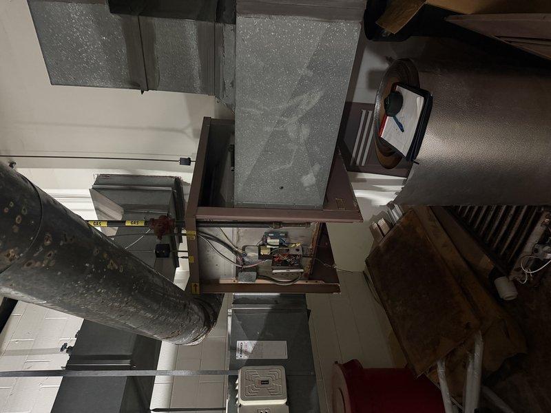 Conducted site assessment of commercial heating system at Safety Kleen facility, examining the existing furnace located in upstairs mechanical room. Evaluated current installation and ductwork configuration to determine replacement options for the 250,000 BTU unit. Customer has received one previous quote and requested comparative estimate for commercial heating equipment replacement.