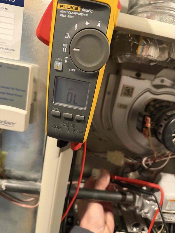 Responded to service call for furnace failure after previous flame sensor replacement in November. Performed electrical diagnostics with Fluke 902FC meter, confirming proper voltage supply at 121V. Inspected blower motor assembly and control board components. Identified and cleaned accumulated debris on replacement flame sensor that was causing intermittent operation failure. System tested and restored to normal operation.