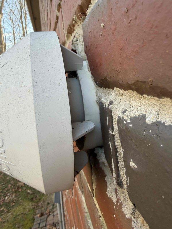 Responded to service call for recurring furnace fault code. Inspected Carrier thermostat system log showing multiple fault events from January. Examined exterior wall vent installation and found improper seating with visible gaps allowing air leakage. Customer currently has heat despite error codes.