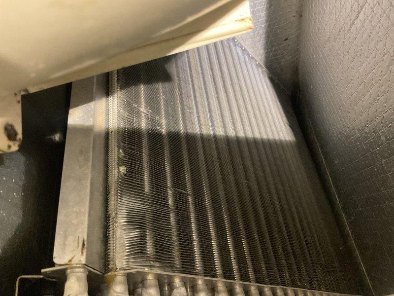 Performed annual heating maintenance on system. Inspected cooling coil and found minor dust accumulation with some bent fins. Checked electrical connections at terminal block and verified proper wire placement in junction box. All components functioning properly after service.