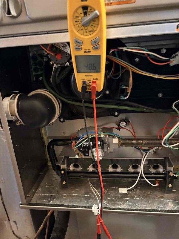 Performed routine heating tune-up on 4-year-old system. Inspected control board functionality with multimeter, verifying proper voltage readings at 4.06V. All wiring connections were verified secure and in good condition, with no issues found in the electrical control system.