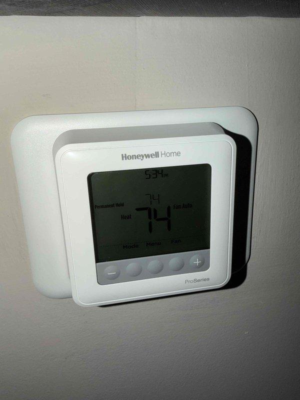 Responded to service call after customer confirmed streets were accessible. Performed inspection of Honeywell Home ProSeries thermostat which was functioning properly at 74°F with proper heat settings and 53% humidity level. Examined furnace system including PVC venting components and filter assembly, all components found in normal working condition.