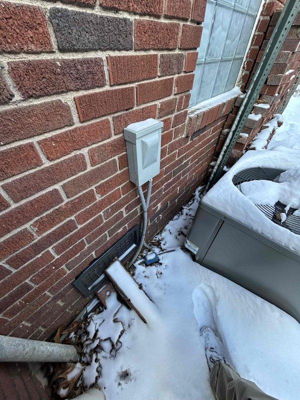 Conducted home estimate for HVAC system replacement. Current installation includes an aging Goodman furnace with visible wiring and components accessible via opened access panel, along with an outdoor condenser unit showing signs of winter exposure and possible ice buildup at base. Customer initiated contact through home show event.