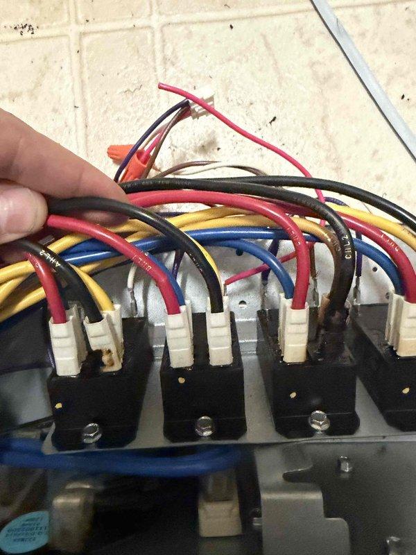 Responded to customer concern of furnace emitting hot smell. Conducted diagnostic inspection of electrical components, examining wiring connections at terminal blocks and relay assembly. All electrical connections were found intact with proper installation; no damage observed to components or wiring insulation despite minor wear.