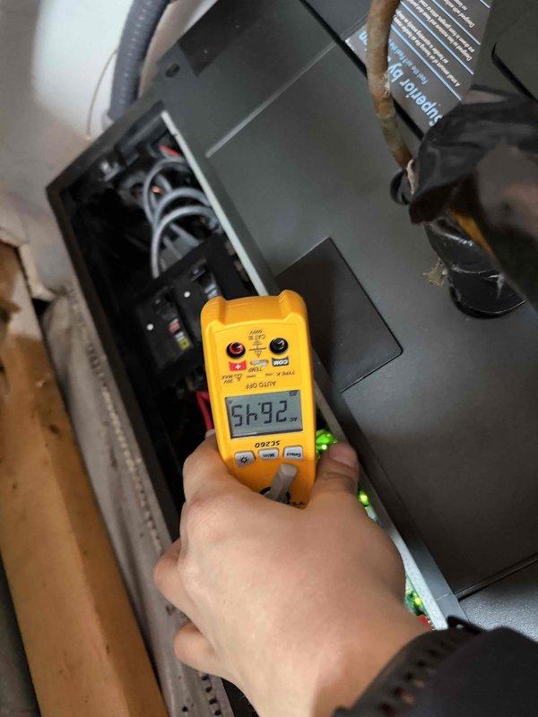 Conducted diagnostic testing on system experiencing sensor reading issues. Utilized multimeter to verify electrical connections and readings at the control panel, measuring 56.92 volts. Customer reported backup heat functioning but suspected communication problems between indoor and outdoor units of the 8-year-old system.