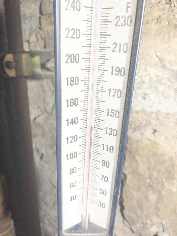 Diagnosed sanctuary heating issue where temperature was limited to 58°F. Verified boilers were operational with proper hot water flow to blower coils, but identified cold return from coils indicating possible air lock in the system. Temperature readings confirmed discrepancy between supply (120-130°F) and return (346°F) temperatures, suggesting circulation problems.
