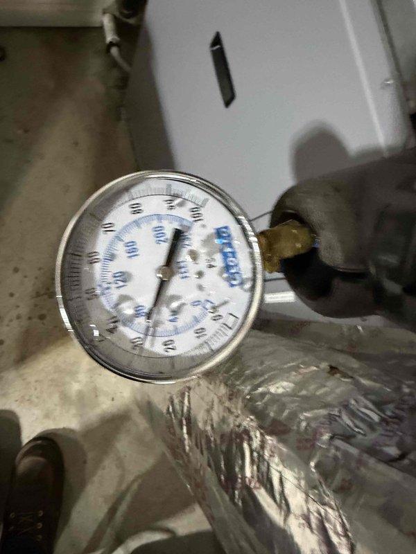 Performed scheduled heating maintenance on a geothermal system. Checked system pressure with Geo-Flo gauge, confirming readings between 60-70 PSI which is within normal operating parameters for this unit.