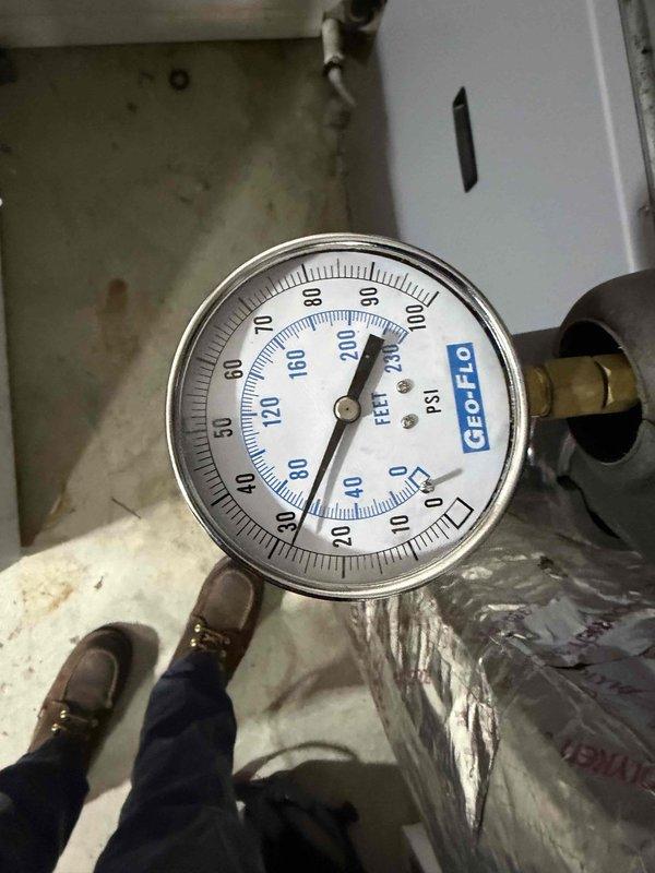 Performed scheduled heating maintenance on a geothermal system. Checked system pressure with Geo-Flo gauge, confirming readings between 60-70 PSI which is within normal operating parameters for this unit.