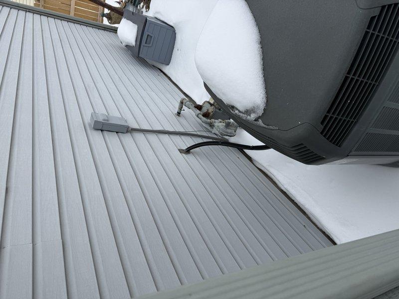 Performed site assessment for full system replacement following prior repair quote. Existing outdoor unit shows significant age with snow accumulation affecting performance. Current installation on deck requires evaluation for proper replacement positioning. Recommended complete HVAC system replacement due to condition of equipment and potential efficiency concerns.