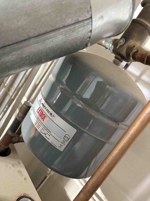 Performed routine heating maintenance on boiler system. Inspected Amtrol expansion tank and associated copper piping connections for proper operation and pressure. Examined circulation pump for functionality, noting minor mineral buildup at brass valve connection points that did not affect performance.