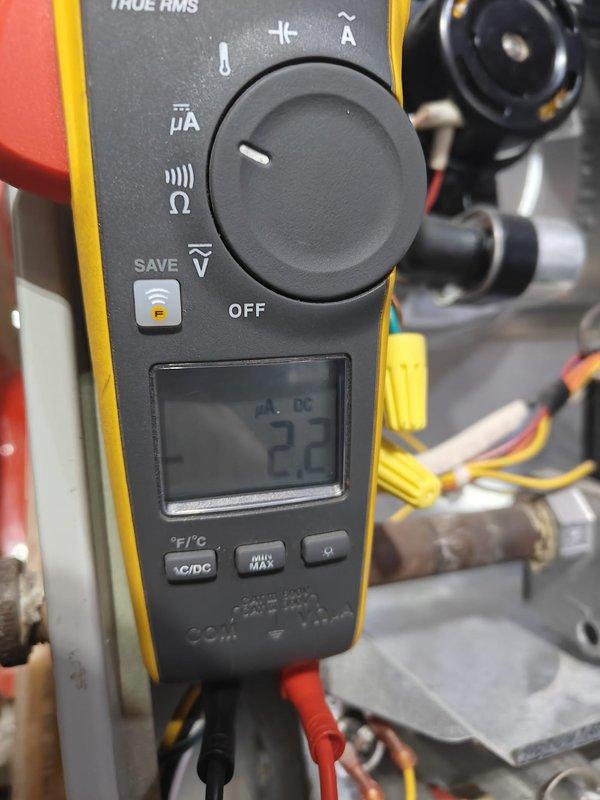 Performed complimentary AC tune-up service as part of contract fulfillment. Conducted voltage testing with multimeter, measuring 2.2 DC volts on system components. Identified and documented significant dust accumulation on equipment requiring cleaning to ensure optimal system performance.