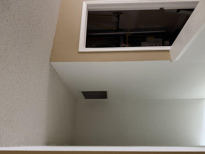 Conducted an estimate for complete HVAC system replacement. Inspected existing wall-mounted thermostat wiring configuration and evaluated current system installation including ductwork and air return placement. Documented interior access panel location for future installation planning.