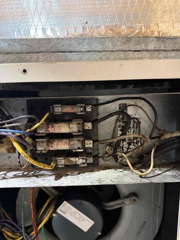 Performed diagnostic testing on geothermal system, measuring 20.1 Amps AC with Fluke 902FC clamp meter. Identified significant corrosion and deterioration on electrical connection panel with multiple fuses/breakers. Completed quoted repairs to address deteriorated wiring connections and electrical components showing signs of heat damage.