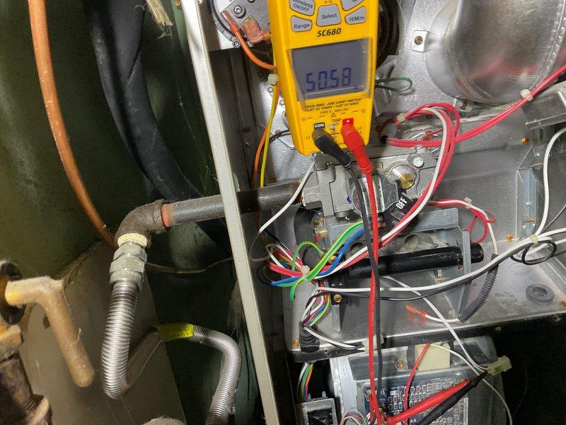 Performed comprehensive tune-up on heating system as requested by customer who reported system maintaining excessive temperature in home. Conducted electrical diagnostics using Fieldpiece SC680 multimeter, measuring voltage readings of 6.058V and 4.5V at various control board connections to verify proper electrical operation. Inspected wiring connections and component functionality to address the overheating concern.