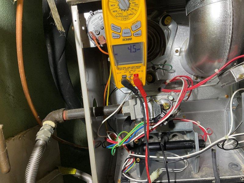 Performed comprehensive tune-up on heating system as requested by customer who reported system maintaining excessive temperature in home. Conducted electrical diagnostics using Fieldpiece SC680 multimeter, measuring voltage readings of 6.058V and 4.5V at various control board connections to verify proper electrical operation. Inspected wiring connections and component functionality to address the overheating concern.
