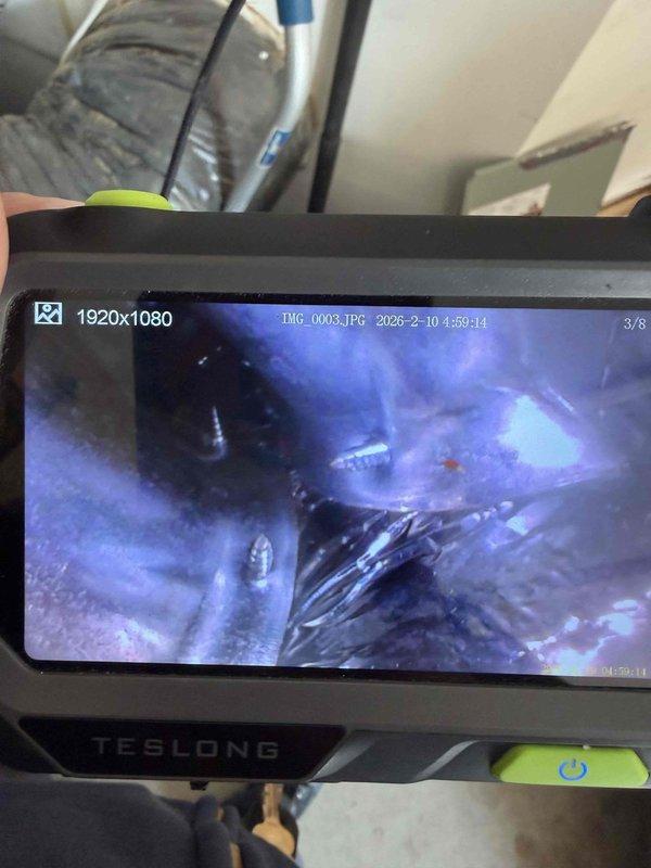 Performed diagnostic inspection on 18-year-old Trane furnace after report of potential crack in heat exchanger. Utilized borescope camera to conduct thorough examination of internal components, confirming presence of heat exchanger damage. Discussed repair options with customer and family member regarding unit's age and condition.