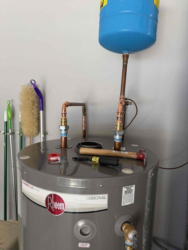 Successfully installed a 75-gallon Rheem Professional water heater under warranty. Completed full setup including copper piping connections, expansion tank mounting, and valve installations. Verified proper operation with flame inspection through viewing window.