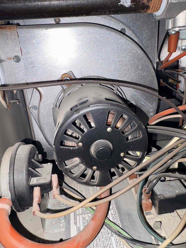 Responded to service call for three malfunctioning hanging heaters. Diagnosed first unit with cycling issues requiring manual reset after each shutdown. Second unit completely non-operational. Third unit missing thermostat connection and associated piping. Inspected blower motor assembly and identified wiring issues and corrosion on connection points. All units accessible via 6-foot ladder.