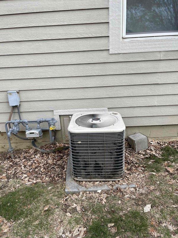 Completed free estimate for furnace replacement and evaluated existing HVAC system. Inspected exterior components including weathered outdoor AC unit on concrete pad with associated electrical connections and disconnect box. Noted current installation condition of utility connections and gas meter/regulator assembly mounted to exterior siding.