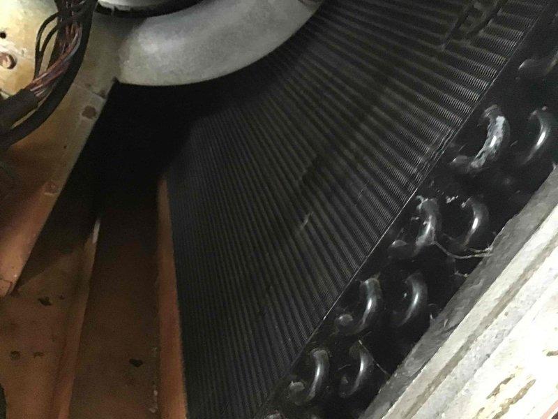 Conducted diagnostic assessment of HVAC system, including detailed inspection of heat exchanger coil/condenser components. Performed electrical testing using clamp meter, recording 15-amp reading on main circuit. Documented condition of internal components showing normal dust accumulation and minor wear consistent with system age.