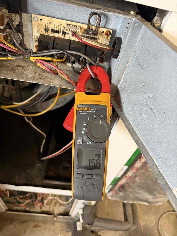Performed annual geothermal heating system maintenance. Conducted electrical testing with clamp meter showing 15.6 amp draw on primary circuit, within normal operating parameters. Inspected heat pump components including control board and copper line connections, noting minor corrosion at connection point that was treated to prevent further deterioration.