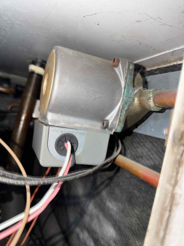 Performed annual geothermal heating system maintenance. Conducted electrical testing with clamp meter showing 15.6 amp draw on primary circuit, within normal operating parameters. Inspected heat pump components including control board and copper line connections, noting minor corrosion at connection point that was treated to prevent further deterioration.