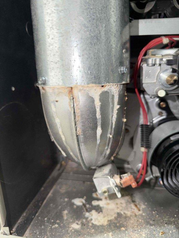 Performed second opinion assessment on aging air conditioning system. Inspected outdoor condensing unit showing signs of weathering but operational condition, and found significant corrosion with mineral deposits on evaporator coil components. Confirmed previous technician's diagnosis that A-coil is missing, presented repair options versus full system replacement recommendation due to unit's age exceeding 10 years and visible deterioration.