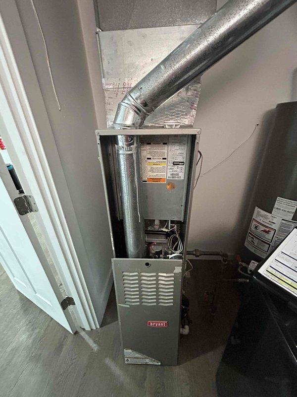Performed a second opinion inspection on a Bryant HVAC system after customer reported concerns about a missing A-coil and potential system replacement recommended by another company. Visual inspection of the furnace unit revealed all components were properly installed and in good working condition, with no evidence of missing A-coil. Recommended maintenance rather than full system replacement as the existing Bryant system appears to be functioning correctly with all components present and properly connected.