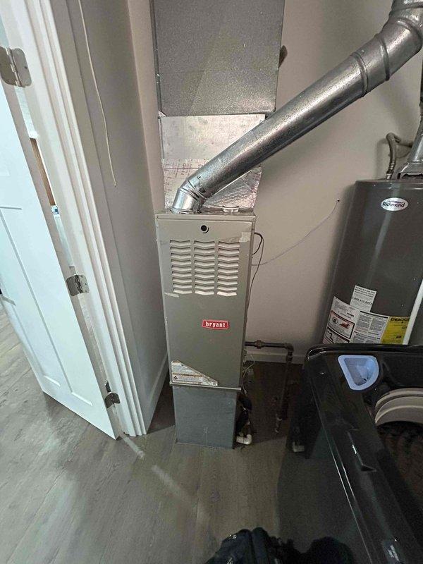 Performed a second opinion inspection on a Bryant HVAC system after customer reported concerns about a missing A-coil and potential system replacement recommended by another company. Visual inspection of the furnace unit revealed all components were properly installed and in good working condition, with no evidence of missing A-coil. Recommended maintenance rather than full system replacement as the existing Bryant system appears to be functioning correctly with all components present and properly connected.