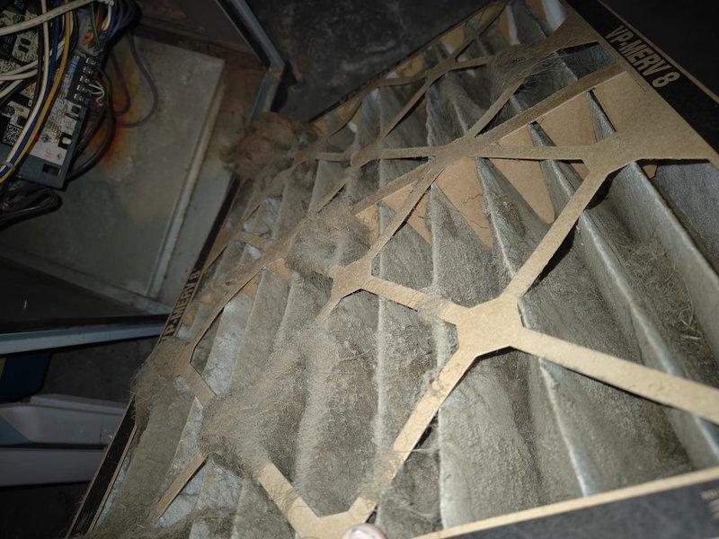 Performed annual heating maintenance service, replacing severely clogged air filter with new one from designated supply box. Conducted system inspection using hex key tool to access control board, checked electrical connections and verified proper operation of heating components.