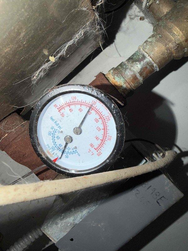 Performed follow-up service call to address corroded copper piping connected to recently installed A.O. Smith Signature 100 water heater. Inspected pressure gauge on system which showed proper reading despite significant oxidation on surrounding pipes. Verified all connections were secure and system was operating within normal parameters.