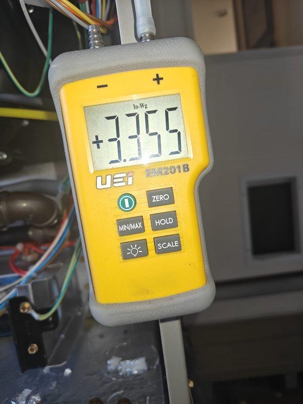 Completed heating maintenance on system. Performed static pressure testing with UEi DM201B meter, measuring both supply (+3.755 In-Wg) and return (1.455 In-Wg) pressure readings to verify proper airflow through the system.