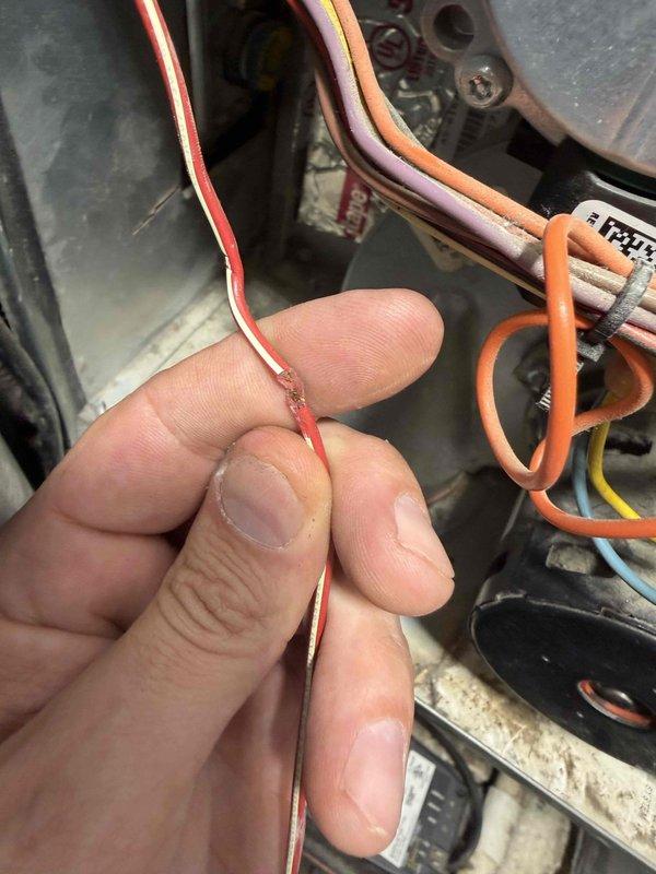 Completed quoted HVAC repair work by replacing damaged electrical wiring in the system. Inspection revealed a red/white striped wire with compromised insulation exposing copper conductor. Replaced damaged wire and verified proper connection to restore system functionality.