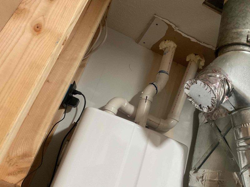 Performed comprehensive installation of a new tankless water heater system integrated with a water filtration unit. Installation included copper pipe connections with appropriate fittings, securing all plumbing connections, and ensuring proper drainage via PVC piping system. Completed electrical connections and verified proper operation of all components before concluding service.