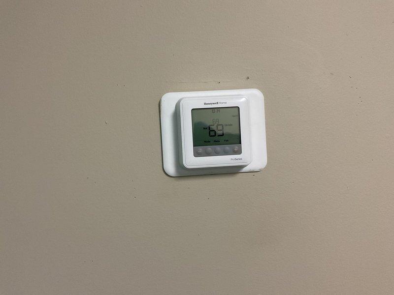Conducted site visit to gather information for maintenance plan development. Inspected Honeywell Home digital thermostat (set at 69°F) and examined the HVAC system's air filter, which was found to be in relatively clean condition with no significant dust buildup. Collected required customer data including unit year, gas type, and refrigerant information.