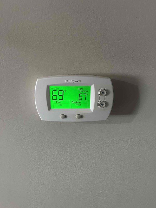 Conducted a second opinion evaluation for furnace replacement. Inspected existing HVAC system including GMC fan unit which appears in normal condition with no visible damage. Noted that installation will require inclusion of a riser box. Documented current Honeywell digital thermostat showing proper operation in heat mode at 69°F indoor temperature with 67°F set point.