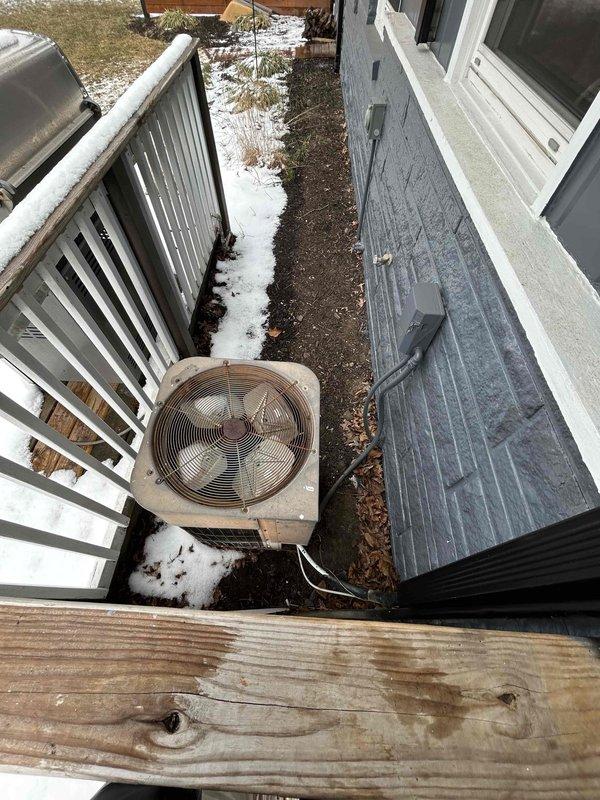 Conducted comprehensive assessment for replacement of 36-year-old AC/air handler system. Evaluated existing outdoor condenser unit showing significant age-related wear and documented the current heating system configuration in utility closet. Noted installation challenges including limited attic access (2'x2' hatch) in ranch-style home with low ceilings, requiring specialized installation planning for the replacement equipment.