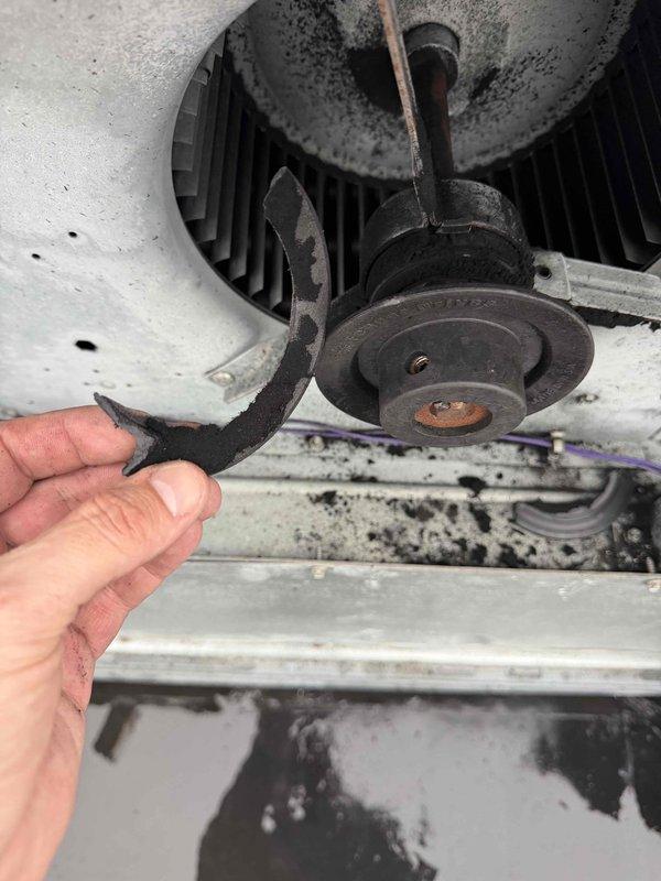 Responded to commercial maintenance customer reporting heating system struggling to maintain temperature. Inspection revealed broken drive belt on furnace blower motor with significant dust/debris buildup throughout system. Temperature testing confirmed system operation at 134.2°F. Replaced damaged belt, cleaned pulley system and surrounding components to restore proper heating function.