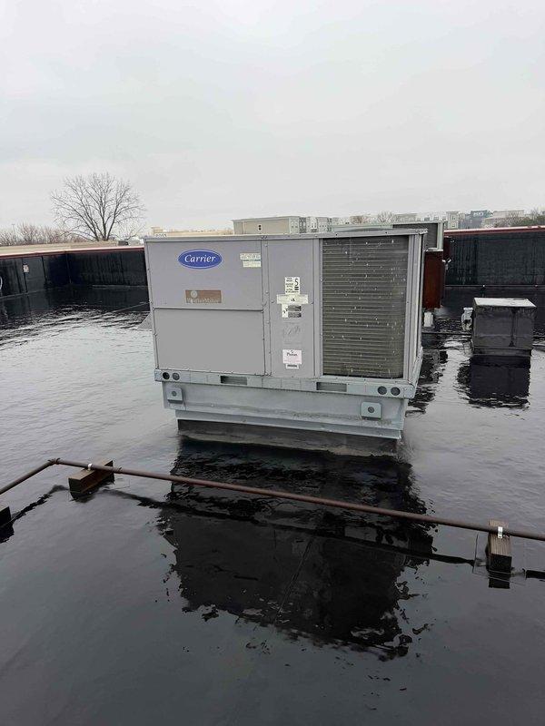 Conducted site assessment to gather information for a maintenance plan on a Carrier rooftop HVAC unit. Documented the equipment's location, condition, and specifications as requested by customer, including unit year, gas type, and refrigerant type. Photographs were taken of both the building exterior access point and the rooftop unit for documentation purposes.