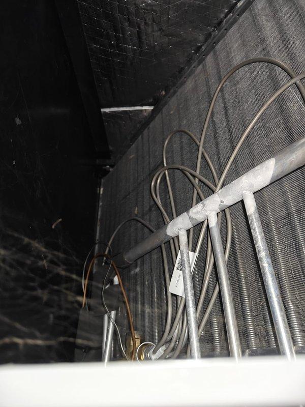 Performed 2025 Heating Maintenance First Service, inspecting evaporator coil assembly which appeared in good condition with no visible damage or excessive dirt accumulation. Control board inspection showed proper operation with illuminated indicator light and well-organized wiring connections.