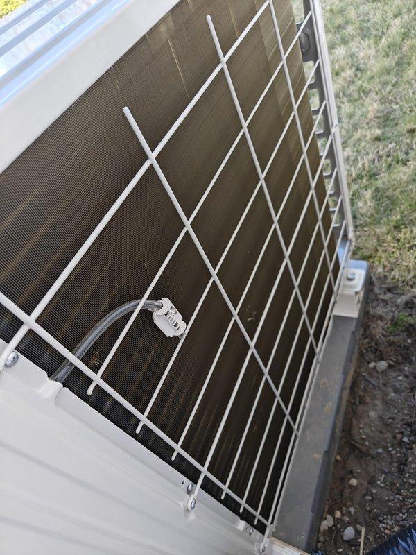 Completed heating maintenance service on residential HVAC system. Inspected exterior unit including protective grid covering, heat exchanger coil, and housing integrity. Examined and verified proper electrical connections at terminal block with all wiring properly secured and color-coded.