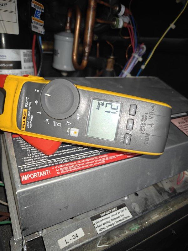 Performed routine cooling maintenance on a geothermal system. Conducted amperage testing on the compressor using a Fluke meter, confirming readings of 12 Amps AC which is within manufacturer specifications. Inspected refrigerant lines, pressure valves, and electrical connections throughout the system, ensuring all components were functioning properly.