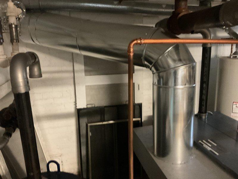 Performed annual heating maintenance on boiler system. Inspected all major components including flue pipes, copper supply lines, and control wiring. System appears to be in normal operating condition with no visible leaks or damage to connections; all valves and safety controls functioning properly.