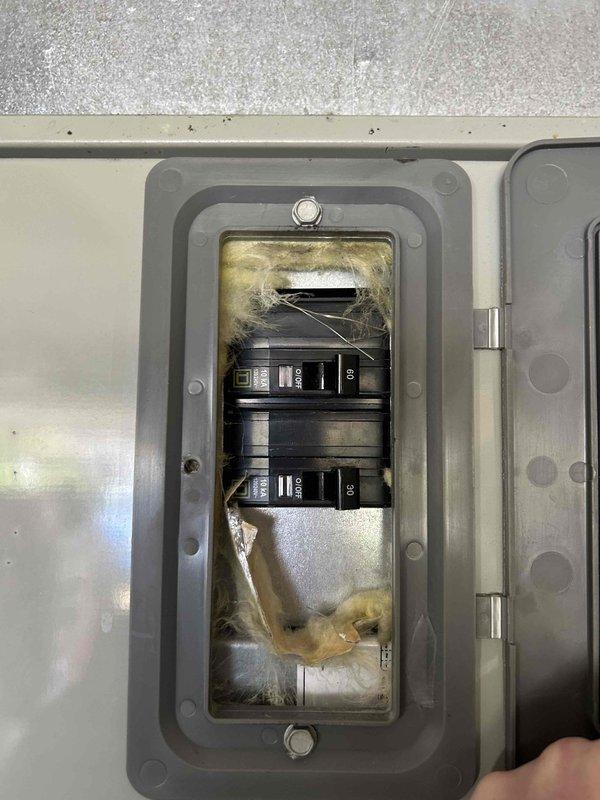 Conducted comprehensive system replacement estimate for 20-year-old HVAC unit. Existing outdoor condenser shows significant age with weathered connections and deteriorated mounting. Electrical inspection revealed concerning dust/debris accumulation in breaker panel with two 50-amp breakers, indicating potential safety hazards requiring attention during replacement.