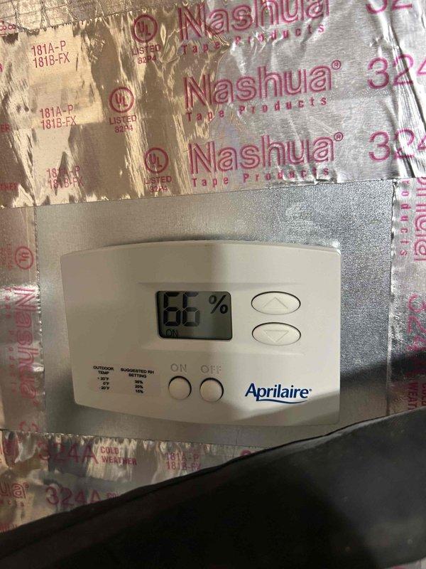 Provided estimate for replacement of existing Lennox outdoor condensing unit with new HVAC system. Current system includes an Aprilaire digital humidity control showing 66% humidity level with visible "OUTDOOR TEMP" and "SUGGESTED RH SETTING" indicators. Replacement recommendation includes appropriate equipment sizing and installation on existing pad with proper electrical connections.