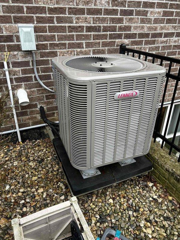 Provided estimate for replacement of existing Lennox outdoor condensing unit with new HVAC system. Current system includes an Aprilaire digital humidity control showing 66% humidity level with visible "OUTDOOR TEMP" and "SUGGESTED RH SETTING" indicators. Replacement recommendation includes appropriate equipment sizing and installation on existing pad with proper electrical connections.