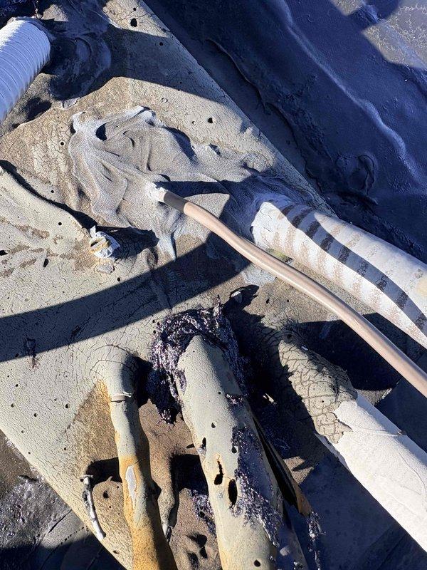 Inspected customer's property regarding water intrusion around RTU flues. Discovered severely damaged roofing membrane with tears and deterioration, allowing water penetration into the building. Documented damaged piping and compromised waterproofing with photos for reference in developing appropriate repair solution.